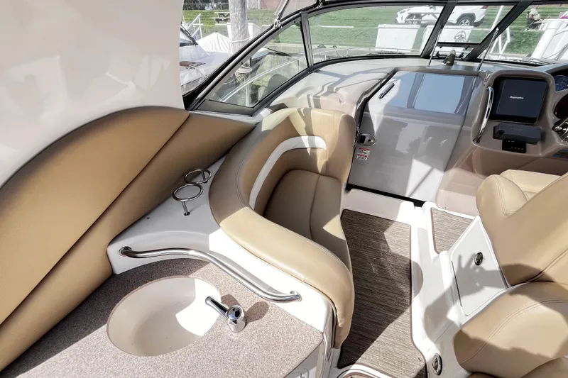 Slide: The Image of Interior of 2004 Sea Ray 320 Sundancer boat with beige seating and helm. - 18