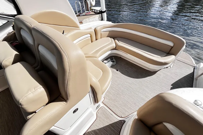 Slide: The Image of Luxurious seating on a 2004 Sea Ray 320 Sundancer boat, docked by the water. - 22