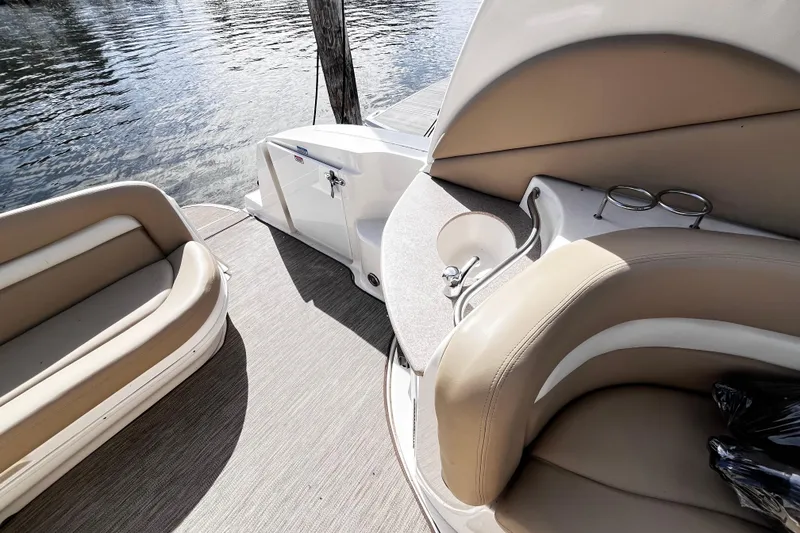 Slide: The Image of 2004 Sea Ray 320 Sundancer boat interior with beige seating and cup holders. - 4