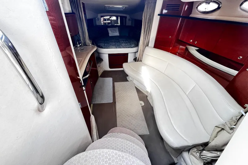 Slide: The Image of Interior of 2004 Sea Ray 320 Sundancer with white seating and wood accents. - 5