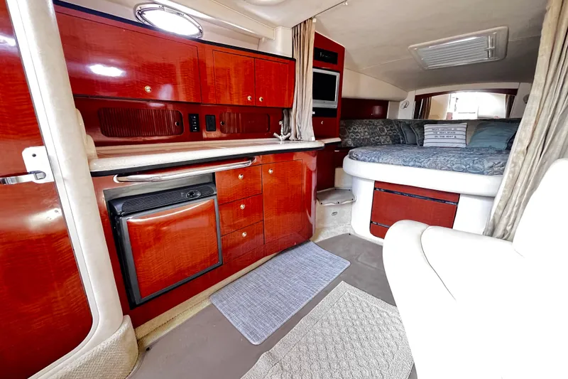 Slide: The Image of Luxurious interior of 2004 Sea Ray 320 Sundancer yacht with kitchenette and cozy sleeping area. - 6