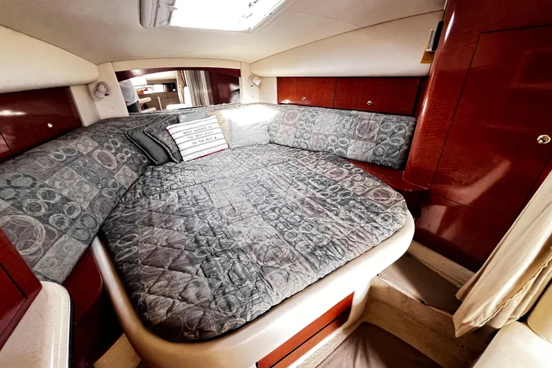 Slide: The Image of Luxurious cabin interior of 2004 Sea Ray 320 Sundancer yacht with cozy bedding. - 8