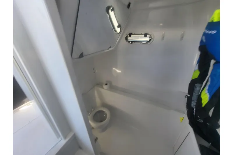 Slide: The Image of 2005 Stamas 310 Tarpon boat interior with compact marine toilet and storage. - 102