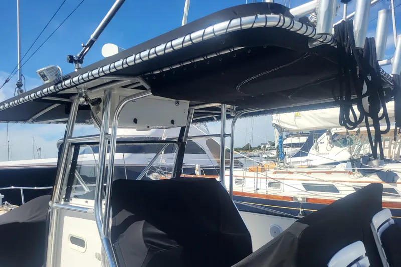 Slide: The Image of 2005 Stamas 310 Tarpon boat with T-top and covered seating at marina. - 13