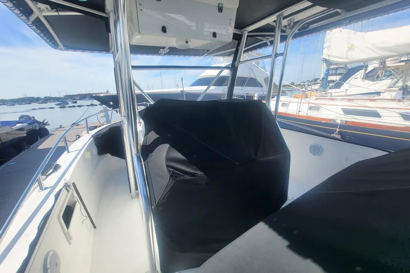 Slide: The Image of 2005 Stamas 310 Tarpon boat interior with covered seating, docked at marina. - 16