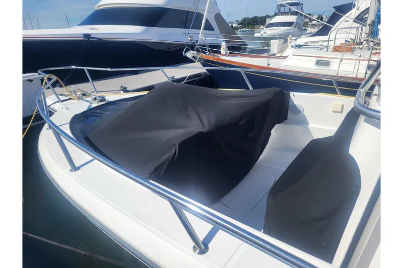 Slide: The Image of 2005 Stamas 310 Tarpon boat with covered seating, docked in a marina. - 17