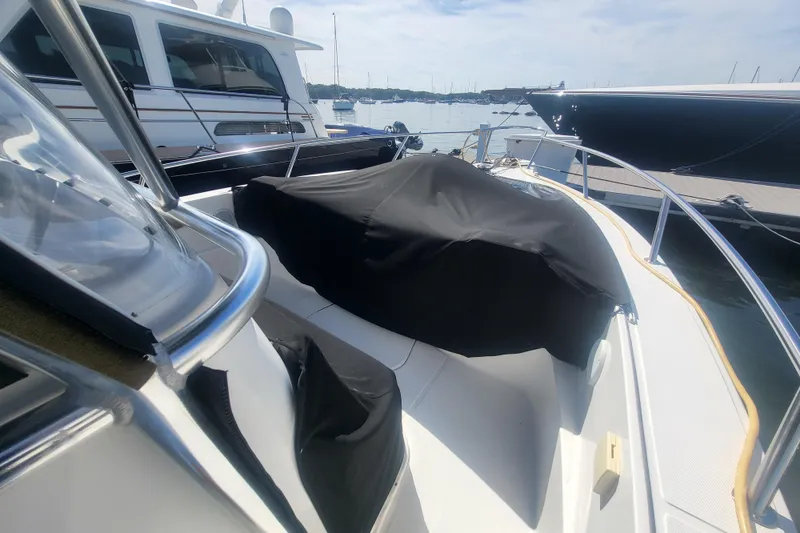 Slide: The Image of 2005 Stamas 310 Tarpon boat docked, featuring covered seating area and sleek design. - 25