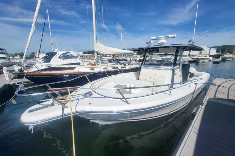 Slide: The Image of 2005 Stamas 310 Tarpon boat docked in a marina under clear blue skies. - 28