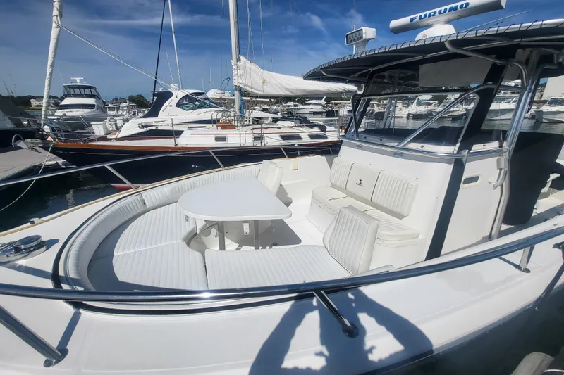 Slide: The Image of 2005 Stamas 310 Tarpon boat with seating area and table, docked at marina. - 29