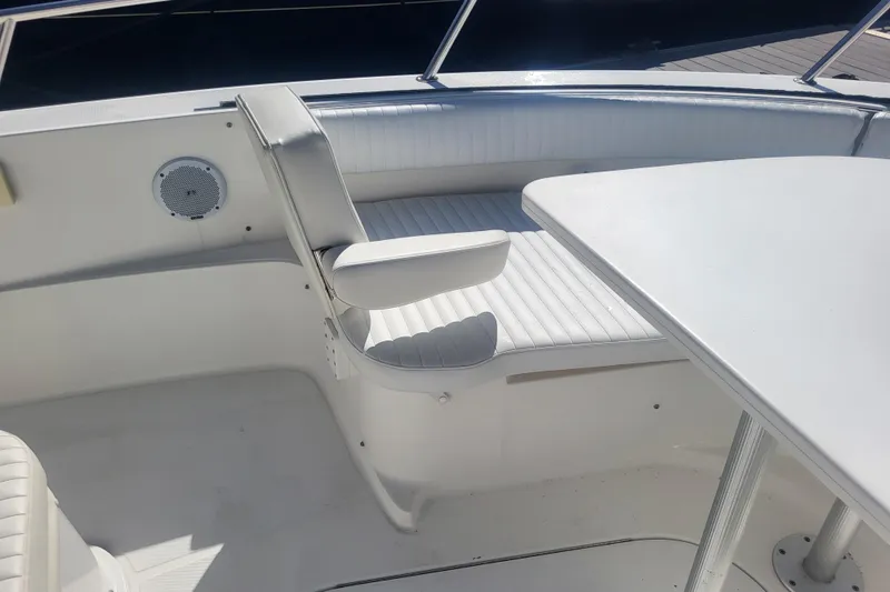 Slide: The Image of 2005 Stamas 310 Tarpon boat interior with white seating and table. - 30