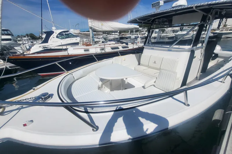 Slide: The Image of 2005 Stamas 310 Tarpon boat docked, featuring spacious seating and sleek design. - 32