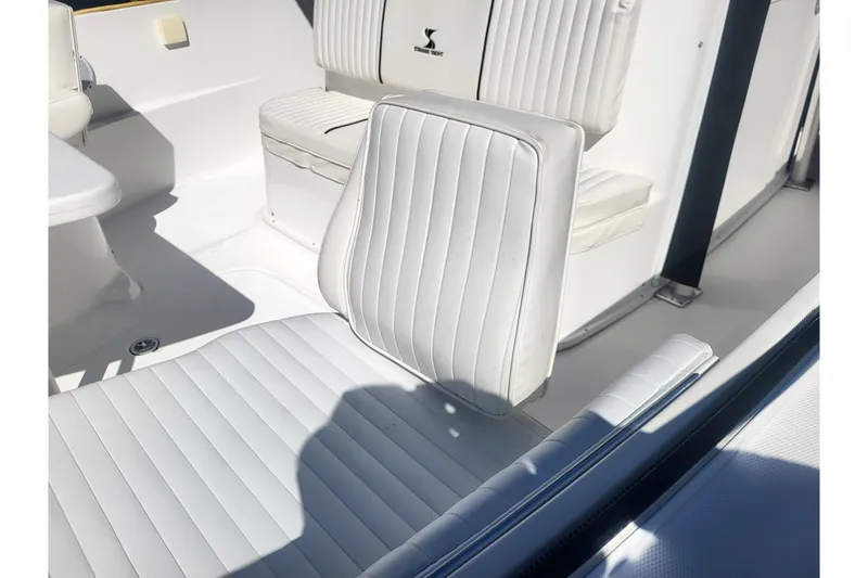Slide: The Image of 2005 Stamas 310 Tarpon boat interior with white cushioned seating. - 34