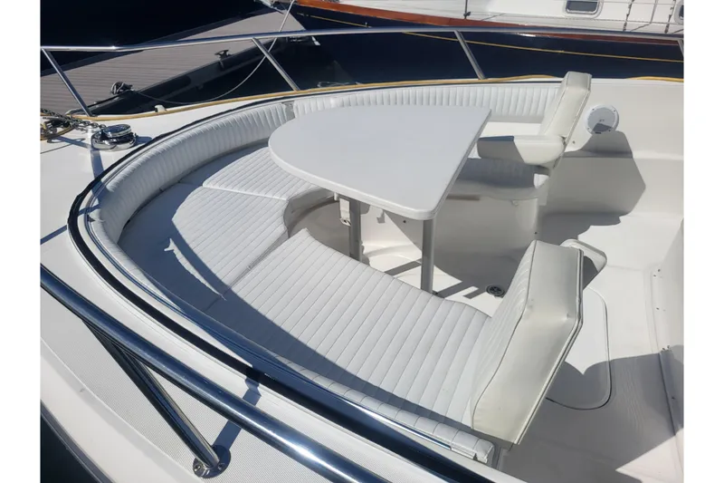 Slide: The Image of 2005 Stamas 310 Tarpon boat interior with white seating and table. - 35