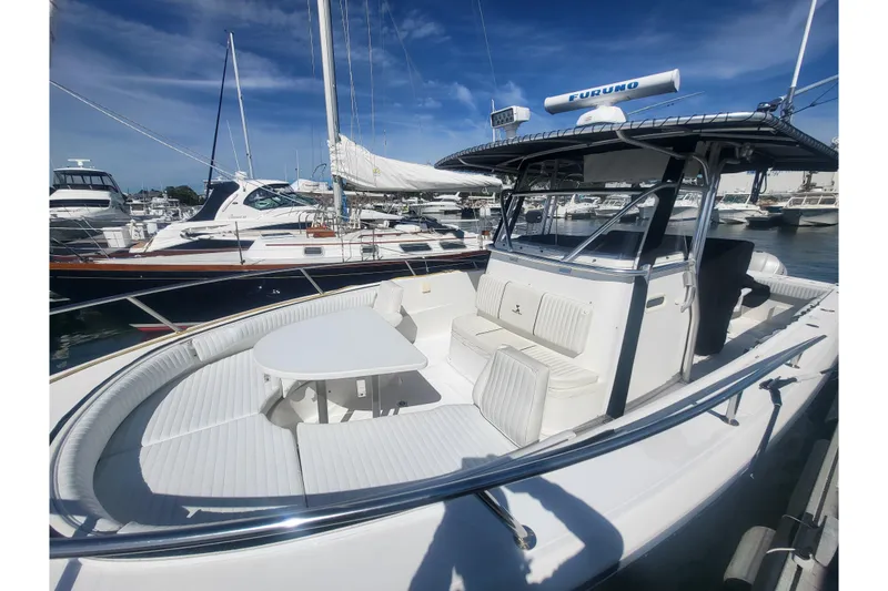 Slide: The Image of 2005 Stamas 310 Tarpon boat docked, featuring spacious seating and sleek design. - 37