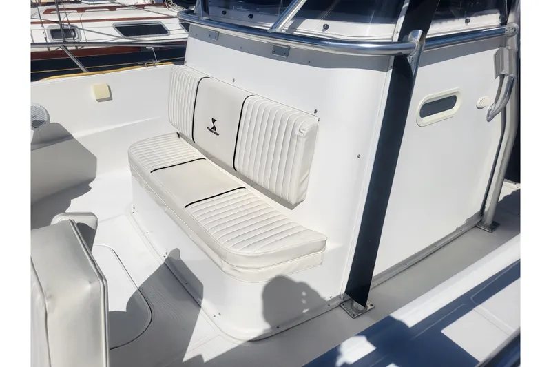 Slide: The Image of 2005 Stamas 310 Tarpon boat interior with white cushioned seating and sleek design. - 39