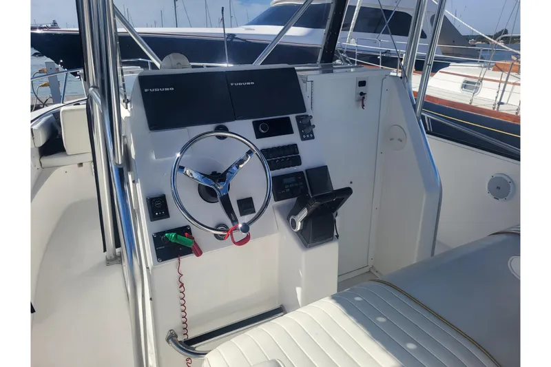 Slide: The Image of 2005 Stamas 310 Tarpon boat helm with steering wheel and navigation equipment. - 43