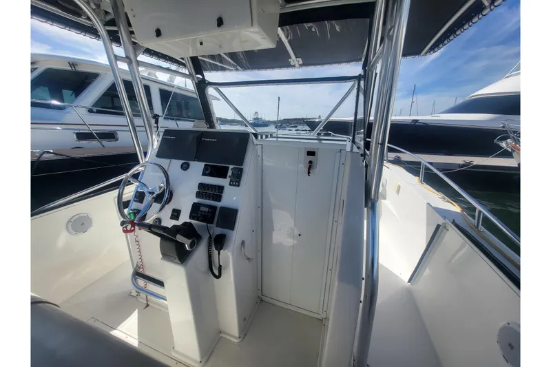 Slide: The Image of 2005 Stamas 310 Tarpon boat cockpit with steering wheel and control panel. - 46