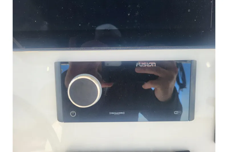 Slide: The Image of Fusion audio system on 2005 Stamas 310 Tarpon boat dashboard. - 58