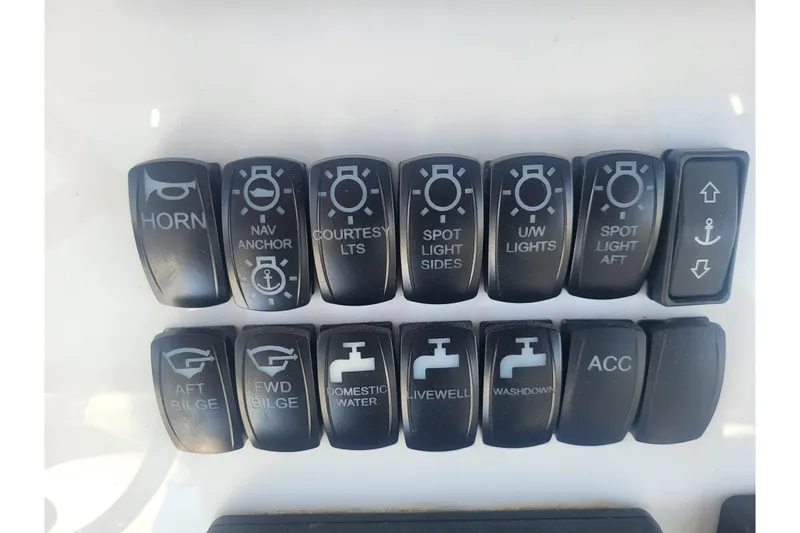 Slide: The Image of Control panel switches on a 2005 Stamas 310 Tarpon boat dashboard. - 59