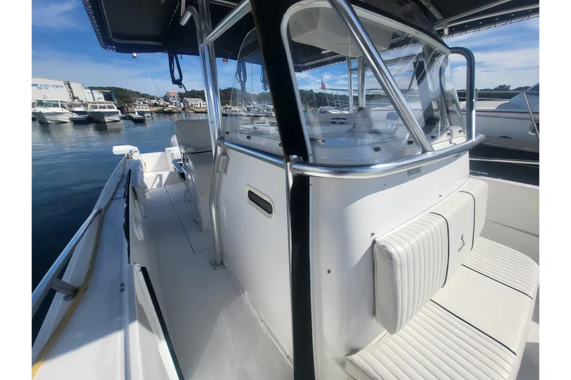 Slide: The Image of 2005 Stamas 310 Tarpon boat interior with seating and console, docked at marina. - 61