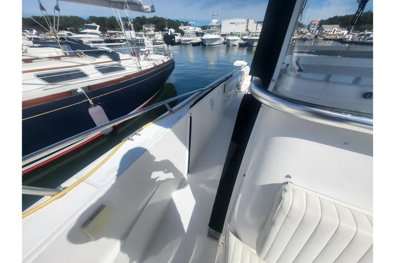 Slide: The Image of 2005 Stamas 310 Tarpon boat docked in a marina, surrounded by other vessels. - 62