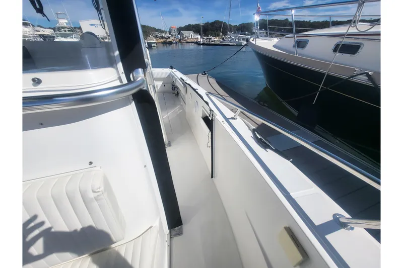 Slide: The Image of 2005 Stamas 310 Tarpon boat interior, docked at marina with clear blue sky. - 63