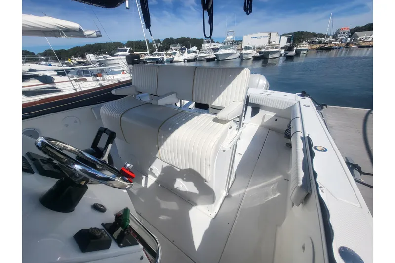 Slide: The Image of 2005 Stamas 310 Tarpon boat interior with white seating at a marina. - 65