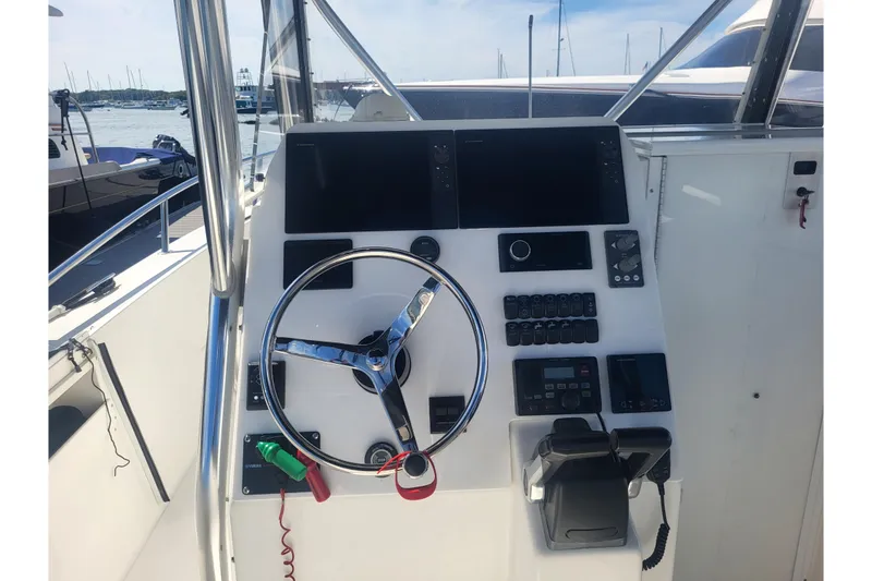 Slide: The Image of 2005 Stamas 310 Tarpon boat helm with steering wheel and control panel. - 68