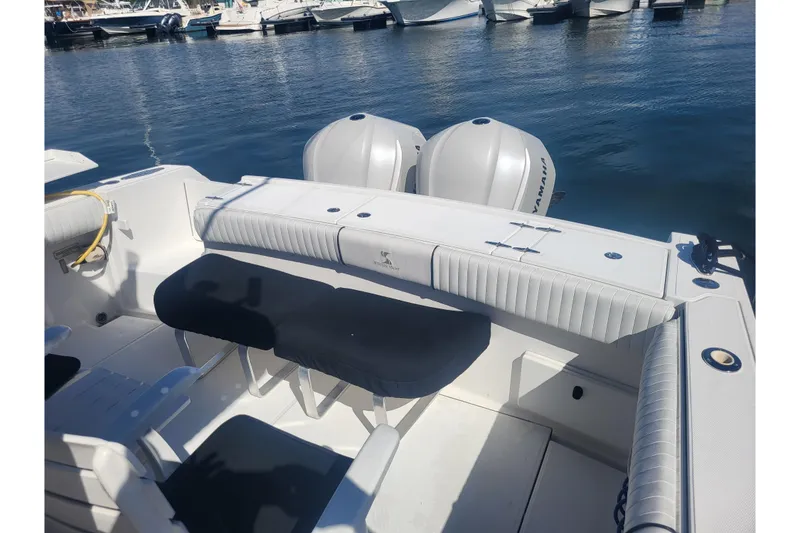 Slide: The Image of 2005 Stamas 310 Tarpon boat interior with dual Yamaha engines, docked at marina. - 69