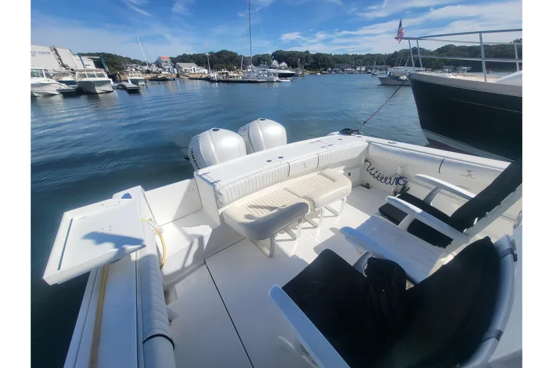 Slide: The Image of 2005 Stamas 310 Tarpon boat interior with seating, docked in a marina under clear skies. - 71