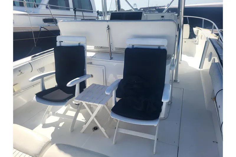 Slide: The Image of 2005 Stamas 310 Tarpon boat interior with two chairs and a small table. - 78