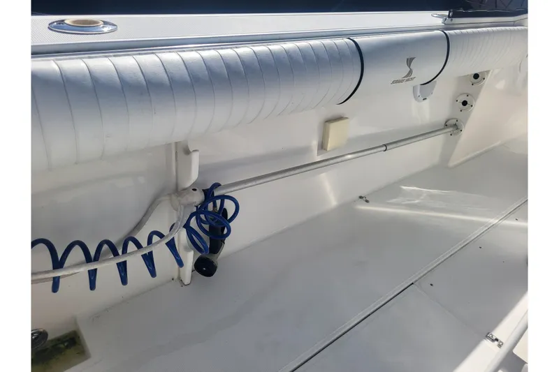Slide: The Image of 2005 Stamas 310 Tarpon boat interior with coiled blue hose and padded railing. - 79