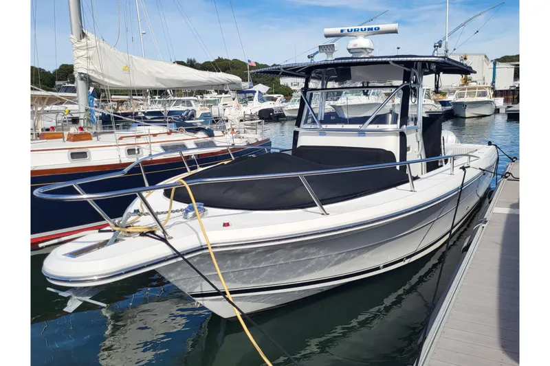 Slide: The Image of 2005 Stamas 310 Tarpon boat docked in a marina, featuring sleek design and modern equipment. - 8