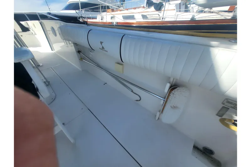 Slide: The Image of 2005 Stamas 310 Tarpon boat interior with white seating and cleaning brush. - 81