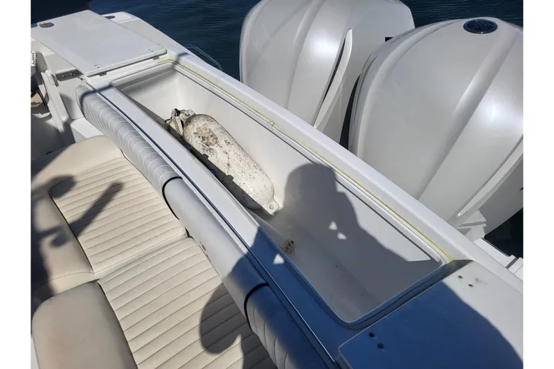 Slide: The Image of 2005 Stamas 310 Tarpon boat interior with storage compartment and dual engines. - 82