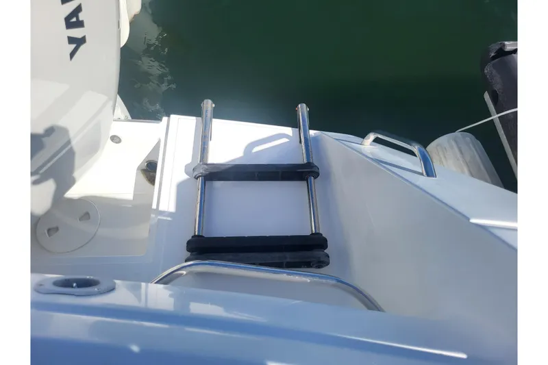 Slide: The Image of 2005 Stamas 310 Tarpon boat ladder and deck area near water. - 84