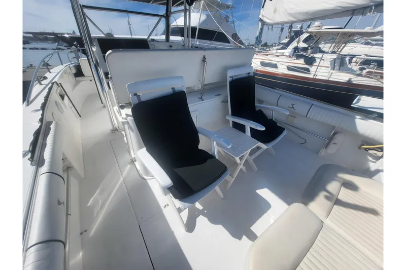 Slide: The Image of 2005 Stamas 310 Tarpon boat interior with seating and table, docked at marina. - 85