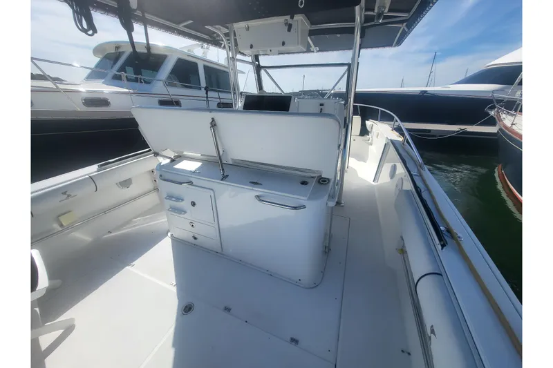 Slide: The Image of 2005 Stamas 310 Tarpon boat interior with open storage, docked alongside other vessels. - 86