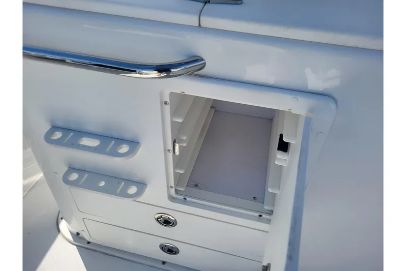 Slide: The Image of Open storage compartment on a 2005 Stamas 310 Tarpon boat, featuring sleek white design. - 88