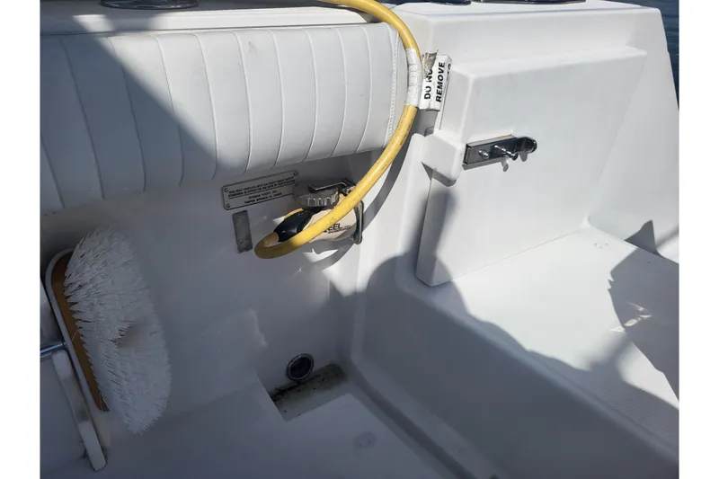 Slide: The Image of 2005 Stamas 310 Tarpon boat interior with hose and cleaning brush. - 90