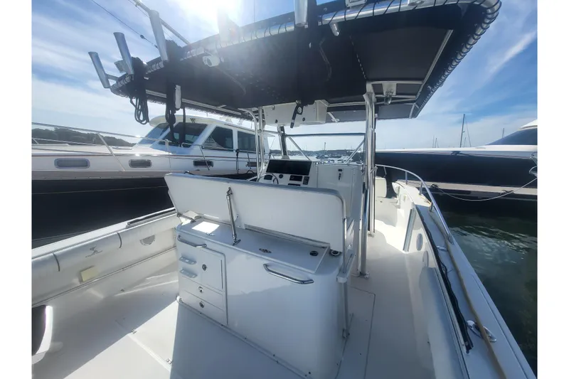 Slide: The Image of 2005 Stamas 310 Tarpon boat interior with T-top and fishing rod holders. - 91