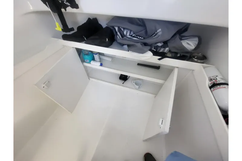 Slide: The Image of 2005 Stamas 310 Tarpon storage area with open compartments and safety equipment. - 97