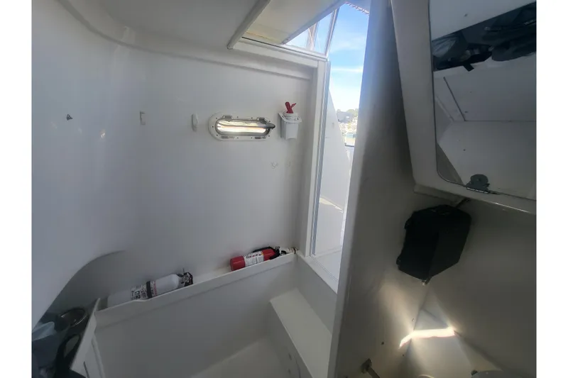 Slide: The Image of Interior of 2005 Stamas 310 Tarpon boat, featuring a compact cabin space. - 99