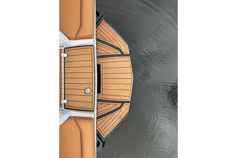 Slide: The Image of 2021 Nautique Super Air Nautique G23 swim platform with teak finish on water. - 11