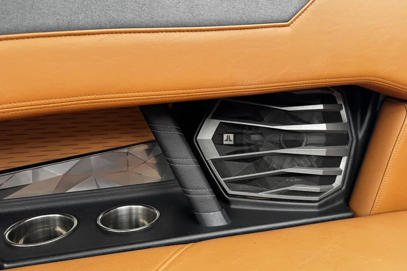 Slide: The Image of 2021 Nautique Super Air Nautique G23 interior with premium speaker and cup holders. - 14