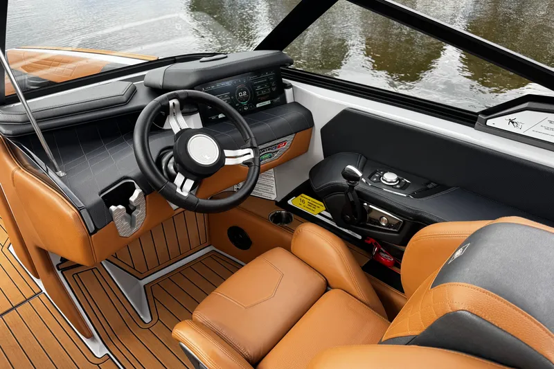 Slide: The Image of 2021 Nautique Super Air Nautique G23 boat interior with leather seats and modern dashboard. - 15
