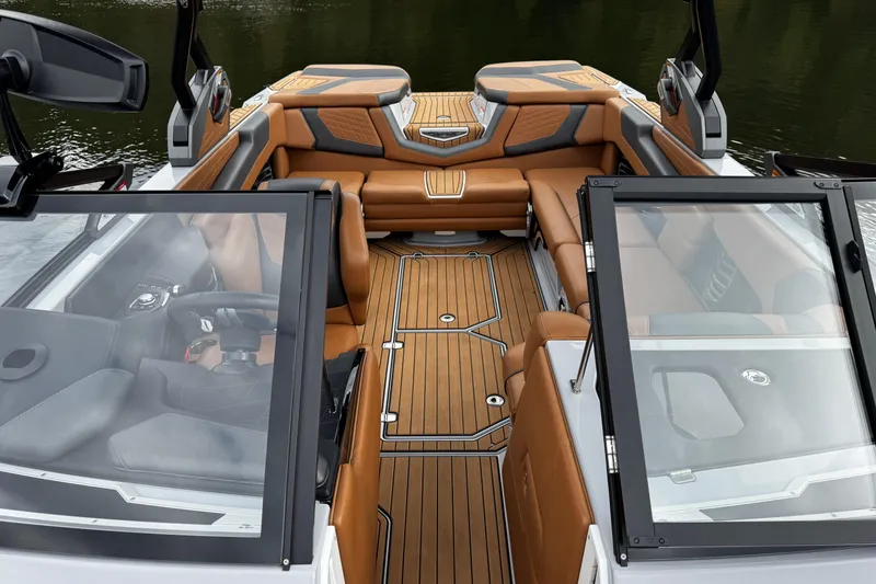 Slide: The Image of 2021 Nautique Super Air Nautique G23 interior with luxurious tan seating and sleek design. - 17