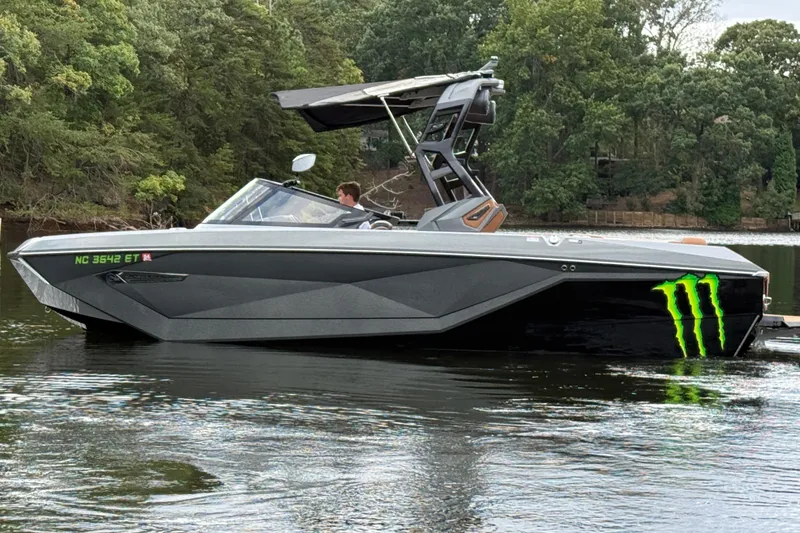 Slide: The Image of 2021 Nautique Super Air Nautique G23 boat on a lake, featuring sleek design and Monster Energy logo. - 3