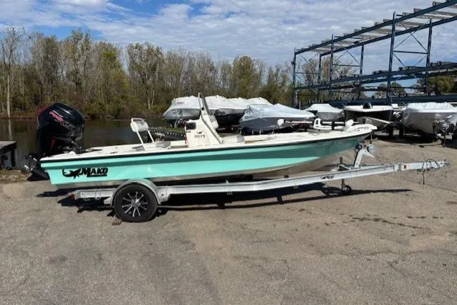 The Image of 2024 Mako 18 LTS boat on trailer, parked outdoors near covered boats. - 1