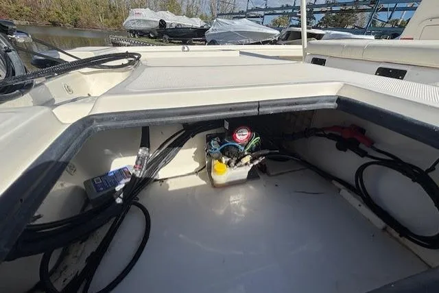 Slide: The Image of 2024 Mako 18 LTS boat interior showing storage compartment and wiring. - 11